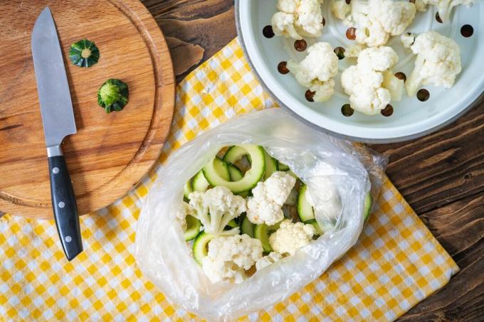 Cauliflower is cut into small pieces and frozen