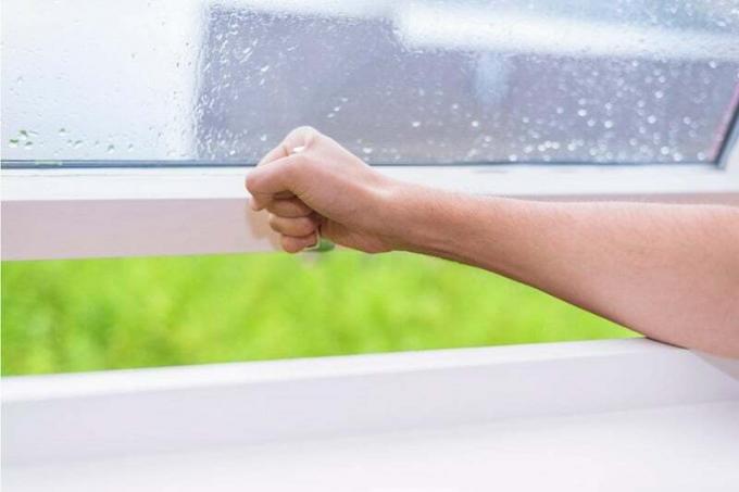 Hand closes window when it rains